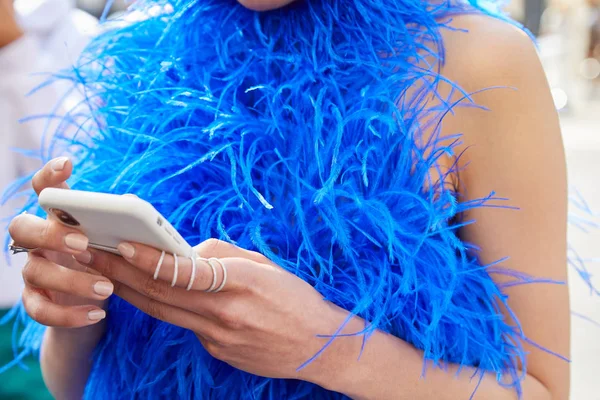 Mulher com penas azuis vestido olhando para o smartphone antes Ermanno Scervino desfile de moda, Milan Fashion Week street style — Fotografia de Stock