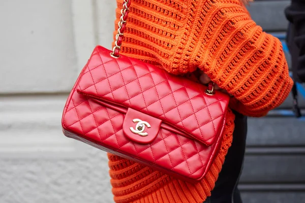 Woman poses for photographers with red Chanel bag, Milan fashion