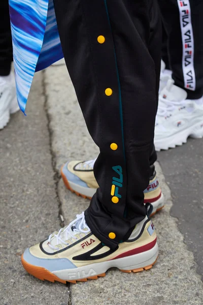 Man with Fila sneakers and black suit trousers before Fila fashion show, Milan Fashion Week street style — Stok Foto