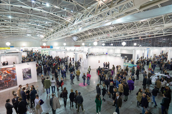 Artissima contemporary art fair opening high angle view at Oval Lingotto palace with visitors in Turin, Italy
