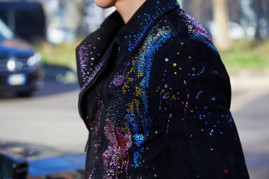 Emporio Armani defilesinden önce renkli boncuklu ve mücevherli siyah ceketli adam, Milan Moda Haftası tarzı. 