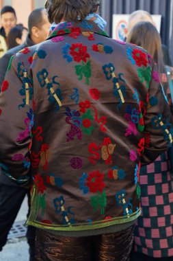 Marni moda defilesinden önce doğu çiçek desenli kahverengi saten ceketli bir adam, Milan Moda Haftası tarzı. 