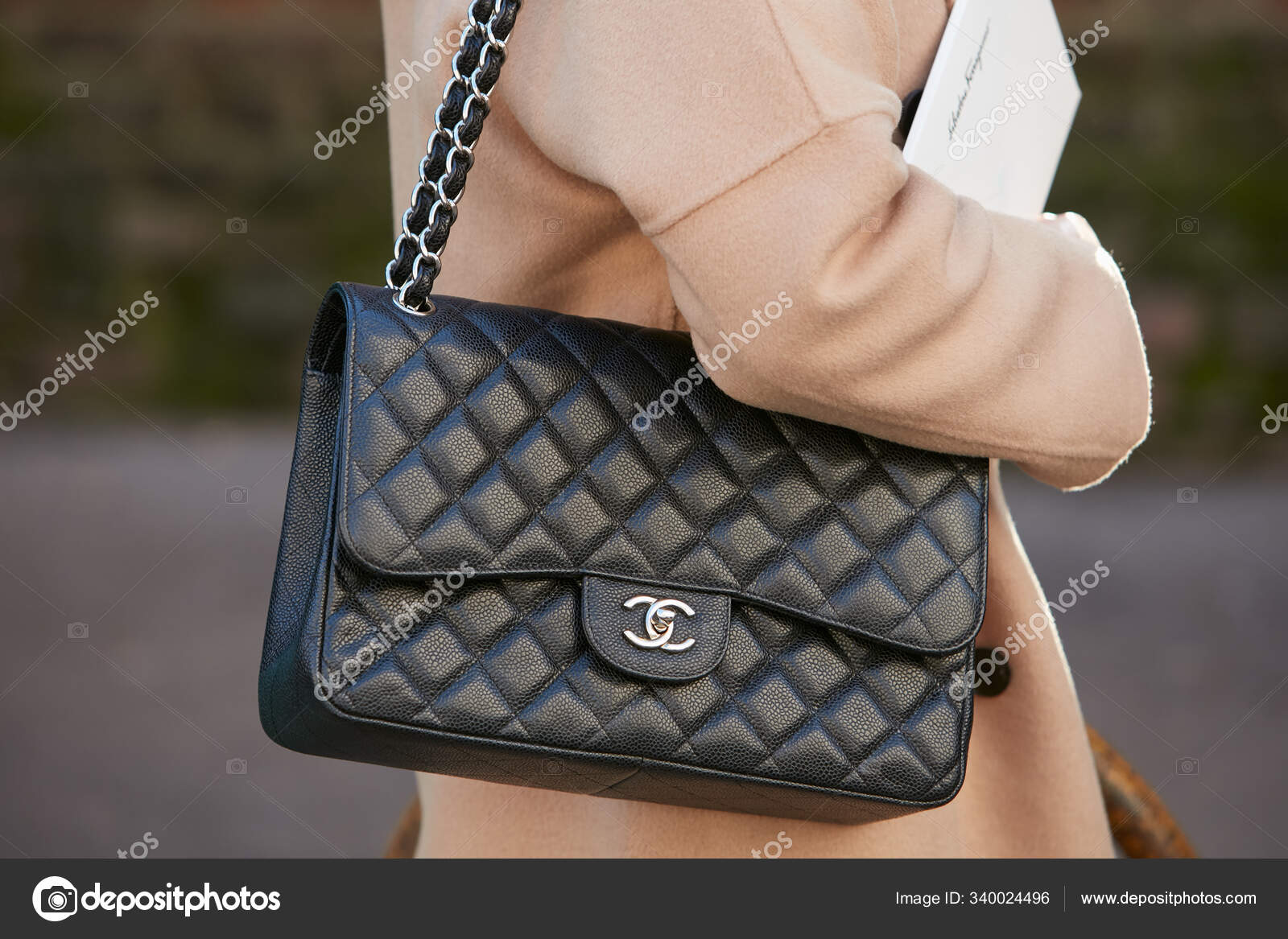 Woman with black leather Chanel bag and beige jacket before Salvatore  Ferragamo fashion show, Milan Fashion Week street style – Stock Editorial  Photo © AndreaA. #340024496