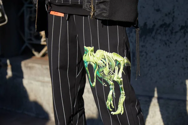 Man met pinstripe broek en groen dinosaurus skelet ontwerp voor Salvatore Ferragamo modeshow, Milaan Fashion Week street style — Stockfoto