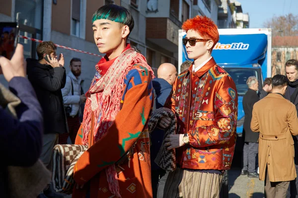 Men with orange jackets with designs before Etro fashion show, Milan Fashion Week street style Stock Photo