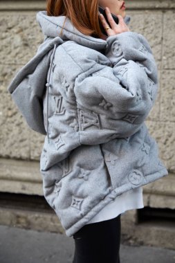 Woman with Louis Vuitton gray jacket with logo relief before Reshake fashion show, Milan Fashion Week street style