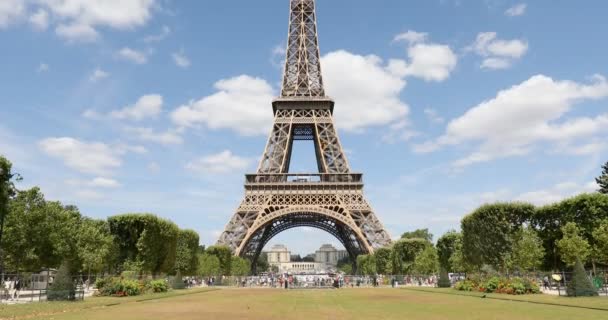 Eiffel-torony Párizsban és a zöld mező a Mars rét, az emberek és a turisták egy napsütéses nyári napon, kék ég — Stock videók