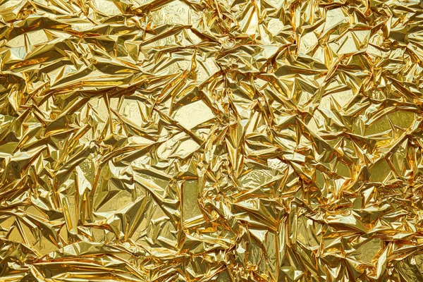 Crumpled, gold metallic foil texture background — Stock Photo, Image