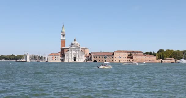 San Giorgio Maggiore-sziget és bazilika Velencében csónakok elhaladnak egy napos napon Olaszországban — Stock videók