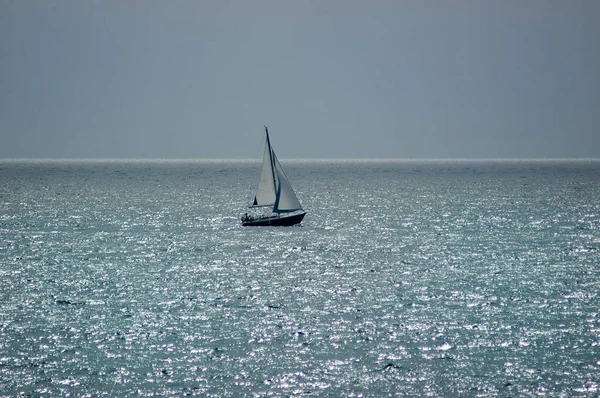 Hot and dusty unusual calima day with an isolated sailing boat, in Tenerife, Canary Islands