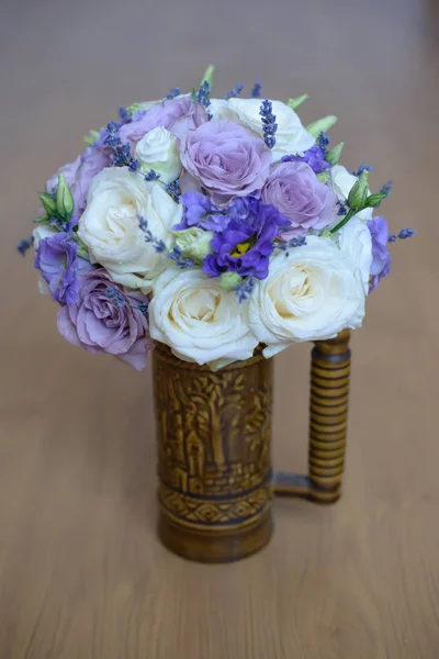 Lavender and roses with purple hues floral arrangement set in a decorated vase with handle — Stock Photo, Image