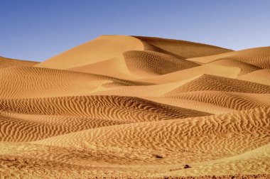 Natural formation of the sand dunes in the Libyan Sahara desert  clipart