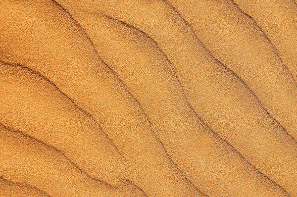 Seamless pattern of golden colored sand