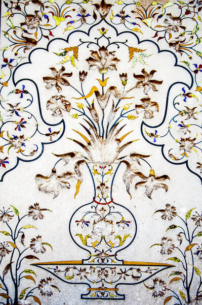 Multicolored floral mosaic art on the white marble 
