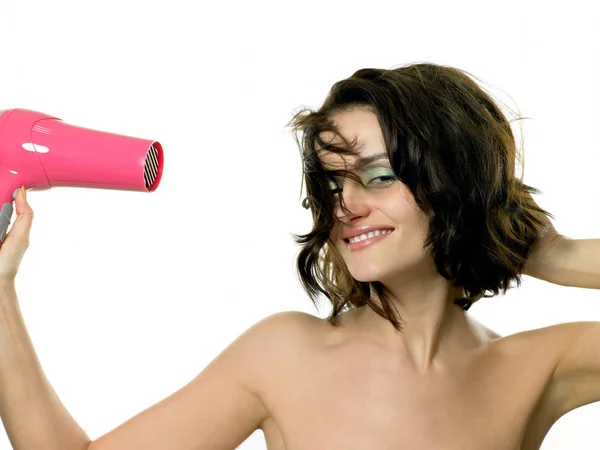 Woman using hairdryer — Stock Photo, Image