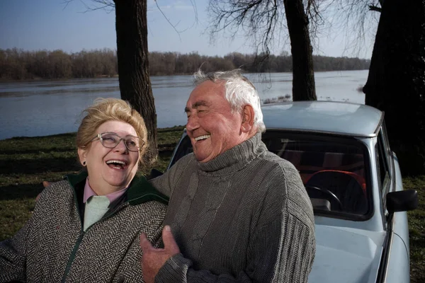 Старшая пара смеется на машине — стоковое фото