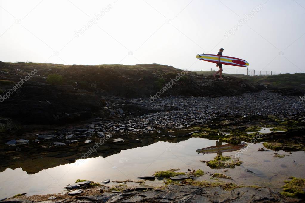 Man walking with surfboard