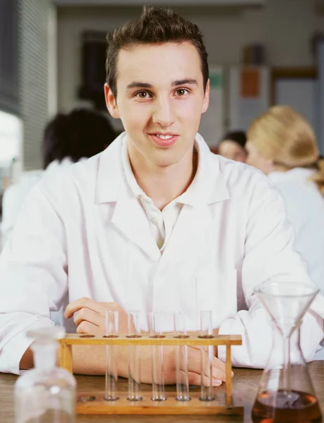 Teenage boy in chemistry class — Stock Photo, Image