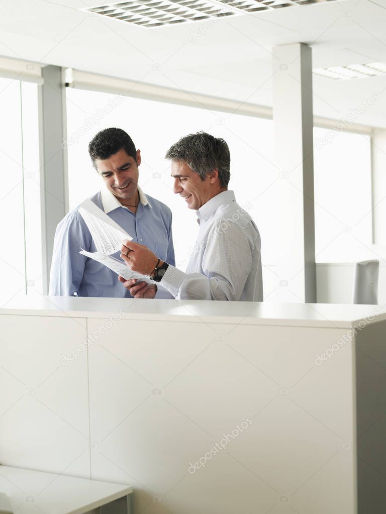 Two businessmen discussing in office, business concept background