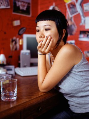 Teenage girl sitting at table clipart