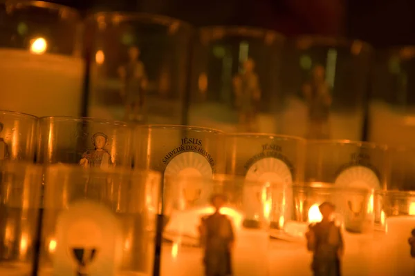 Lit votive candles — Stock Photo, Image