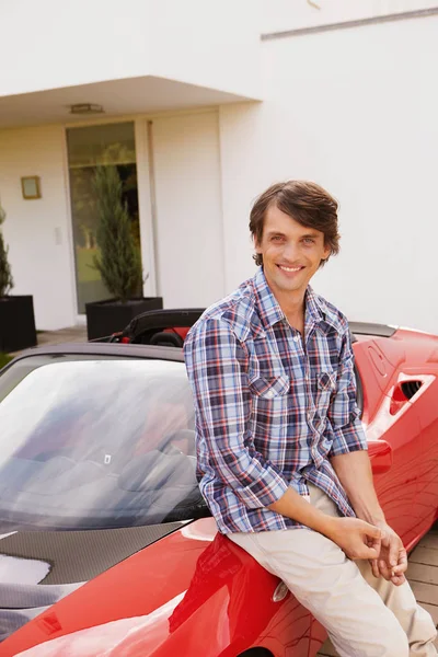 Hombre sentado orgullosamente en su coche eléctrico — Foto de Stock