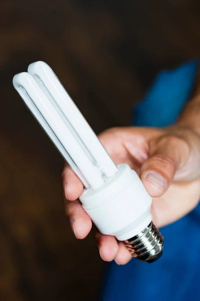 Hand holding energy-saving bulb — Stock Photo, Image