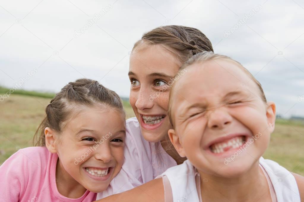  young girls making faces to camera
