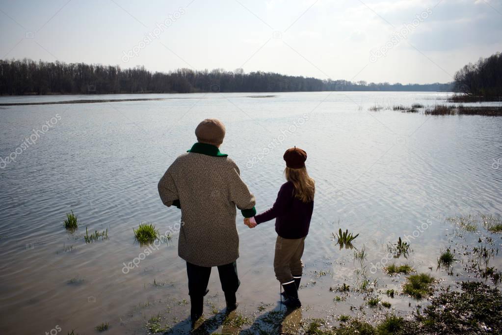 Grandmother and granddaughter in river