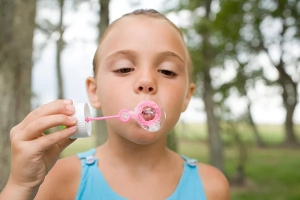 Ragazza utilizzando bacchetta bolla — Foto Stock