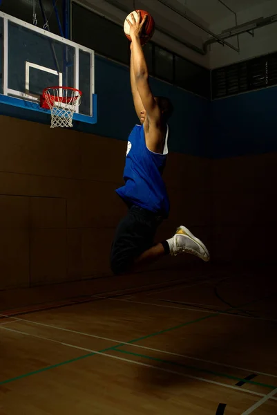 Jugador de baloncesto saltando con pelota — Foto de Stock