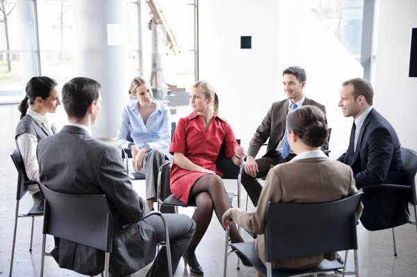 Group of businesspeople sitting in circle — Stock Photo, Image