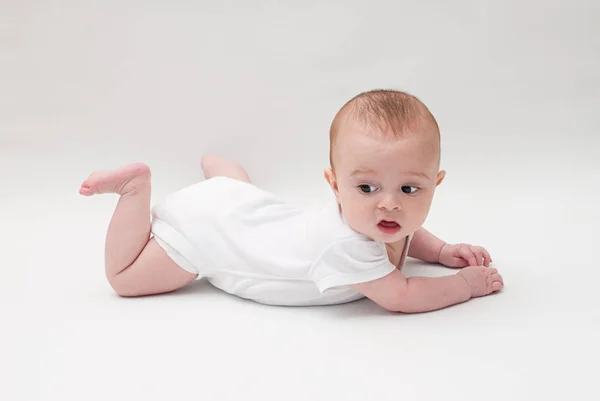 Baby boy lying on white — Stock Photo, Image