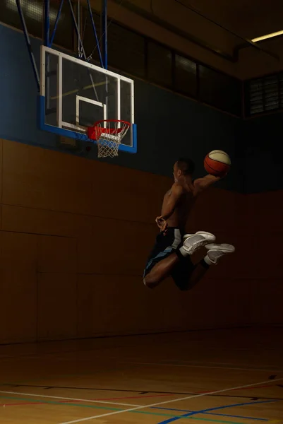 Basketball joueur sautant au cerceau de but — Photo