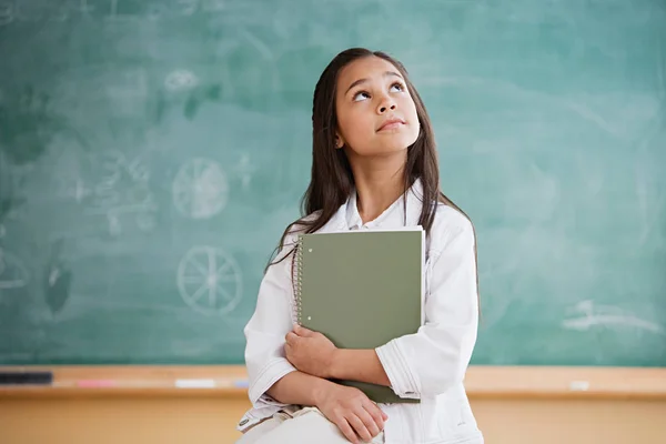 Schoolgirl near blackboard — Stock Photo, Image
