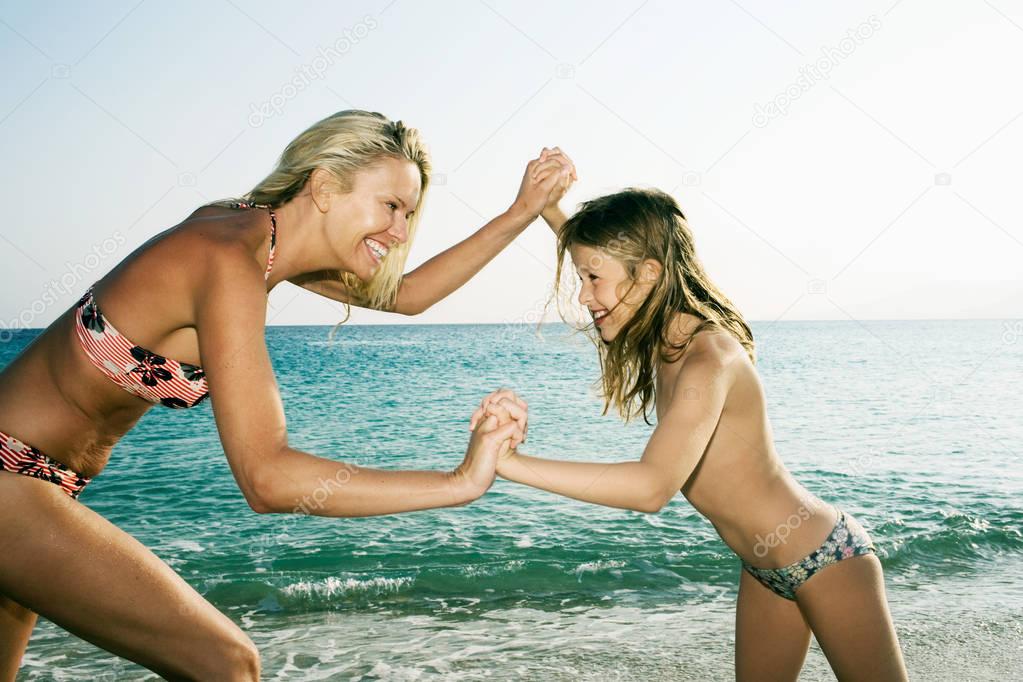 Woman and girl holding hands