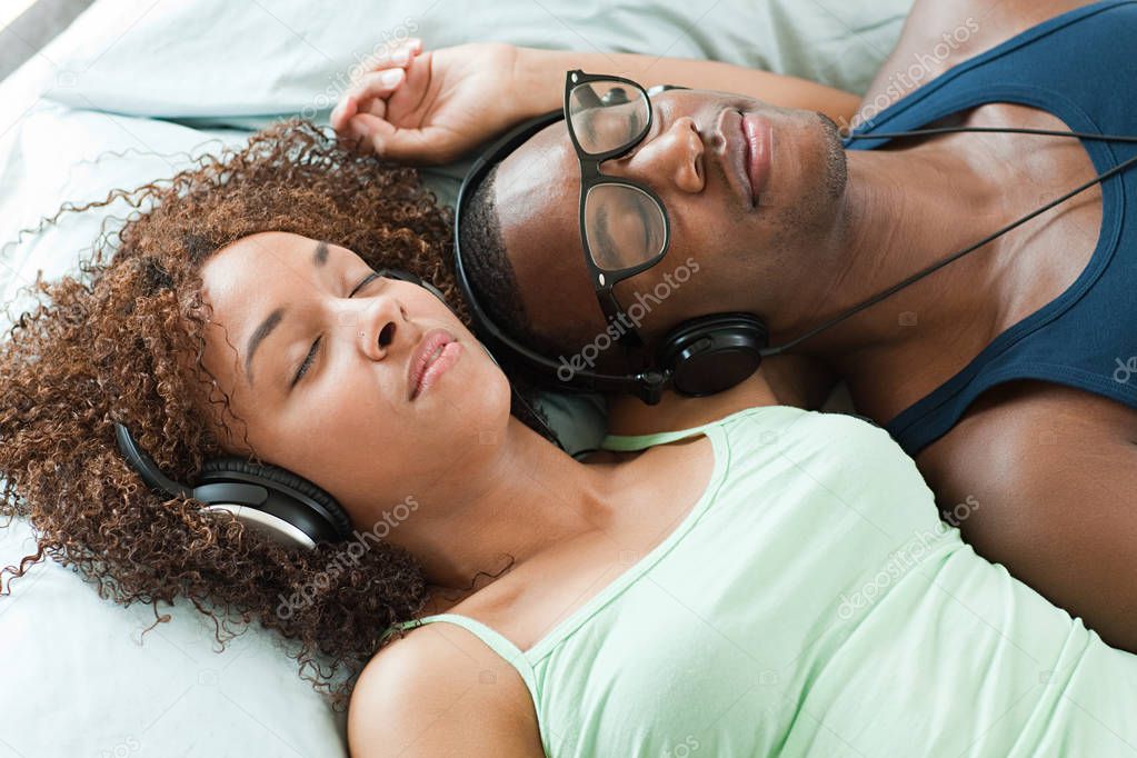 man and woman listening to music