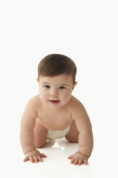 Bebê rastejando e olhando para câmera — Fotografia de Stock