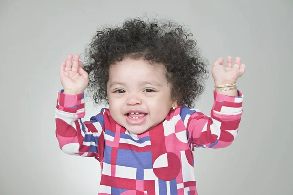 Baby girl holding hands up — Stock Photo, Image