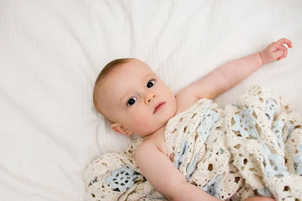 Baby laying with blanket — Stock Photo, Image