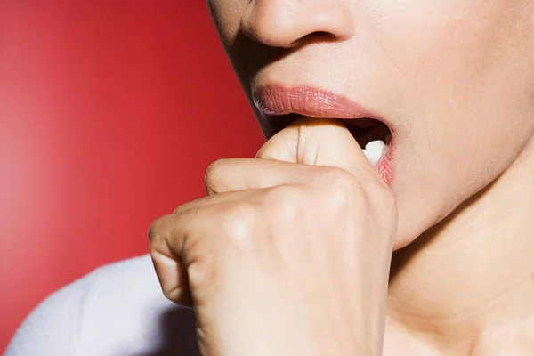 Woman biting knuckle — Stock Photo, Image