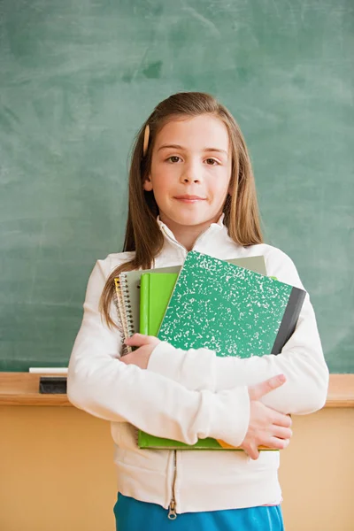 Girl with notebooks standing — Stock Photo, Image