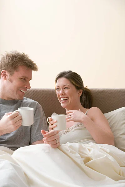 Couple having coffee in bed — Stock Photo, Image