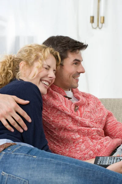 Pareja viendo la televisión y abrazándose — Foto de Stock