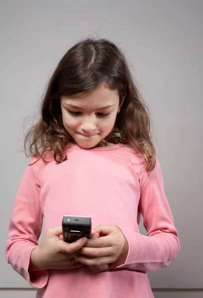 Chica sosteniendo el teléfono móvil — Foto de Stock