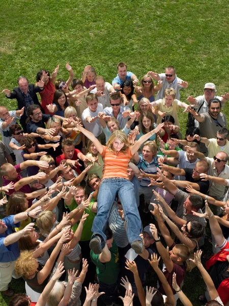 Crowd Bærer Ung Kvinde - Stock-foto