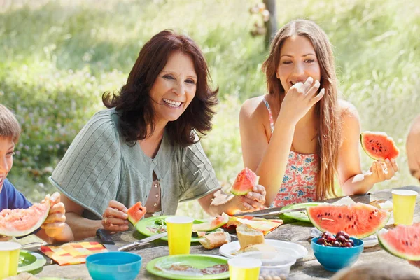 Older woman with daughter at picnic