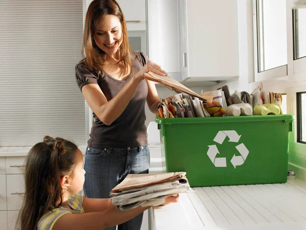 Mother and daughter sharing recycling