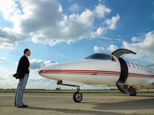 Businessman facing private jet