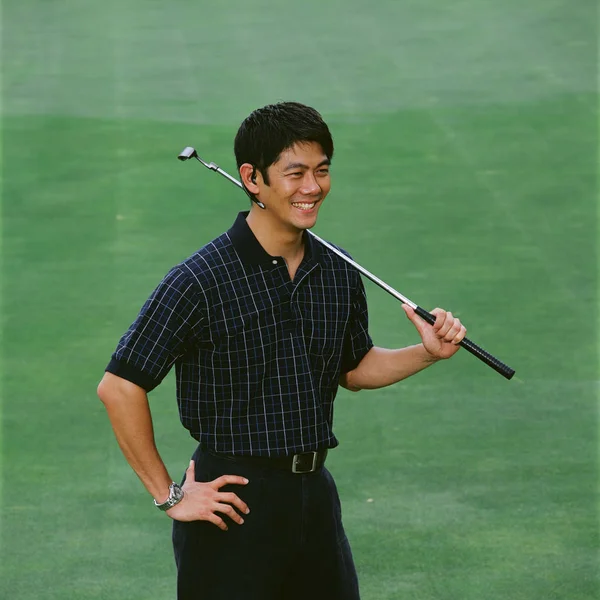 Man on golf green with bluetooth headset